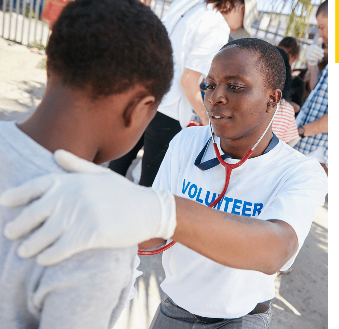 Community volunteer helping young boy