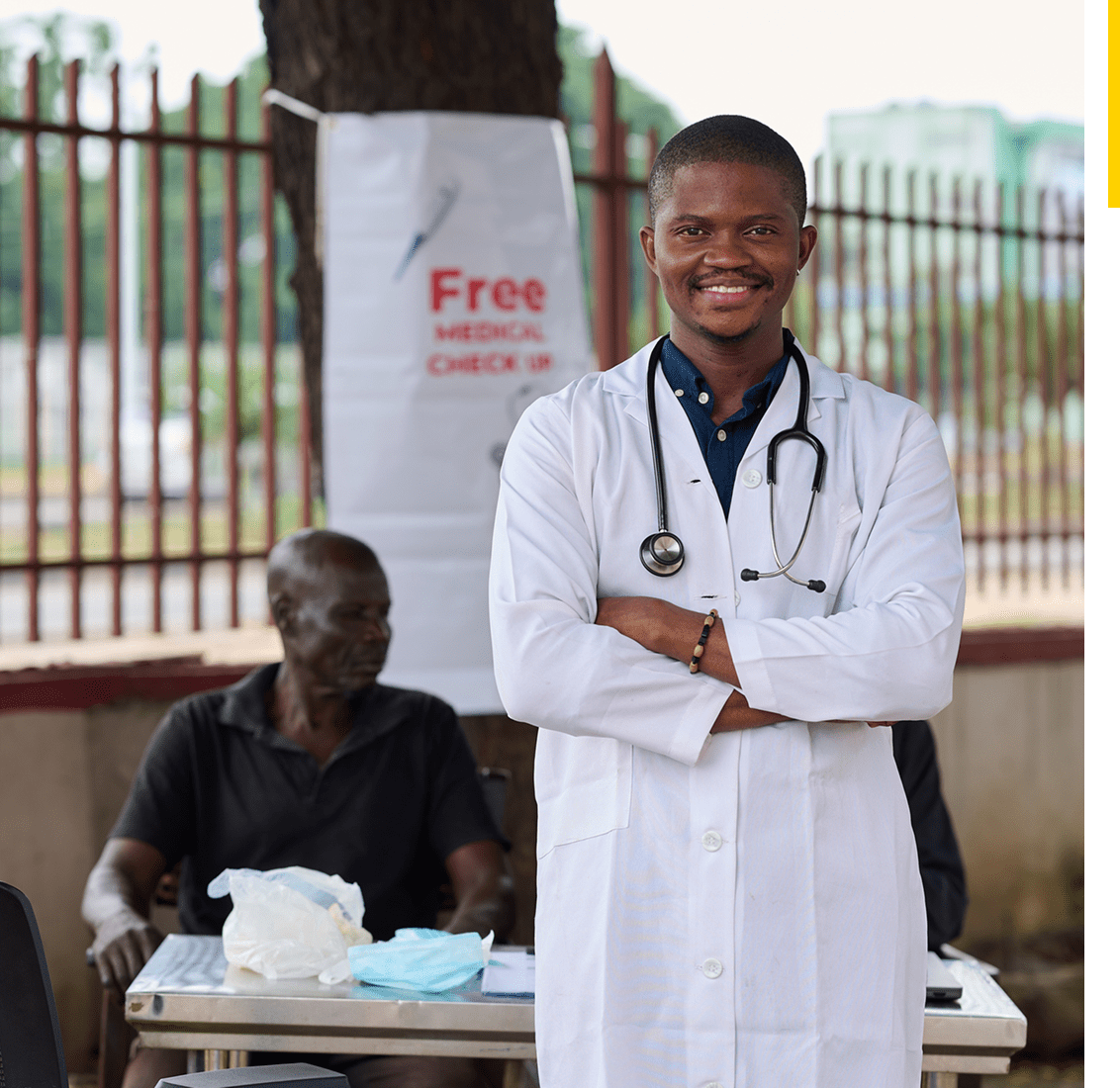 Doctor smiling at outdoor medical camp