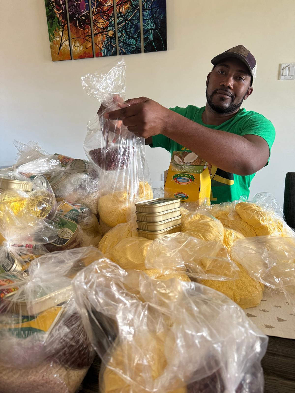 Man packaging food items at a table.