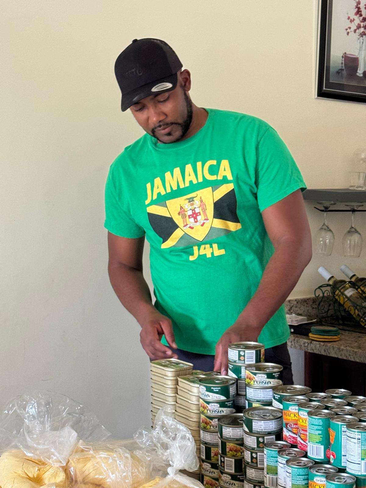 Man organizing canned goods on table.