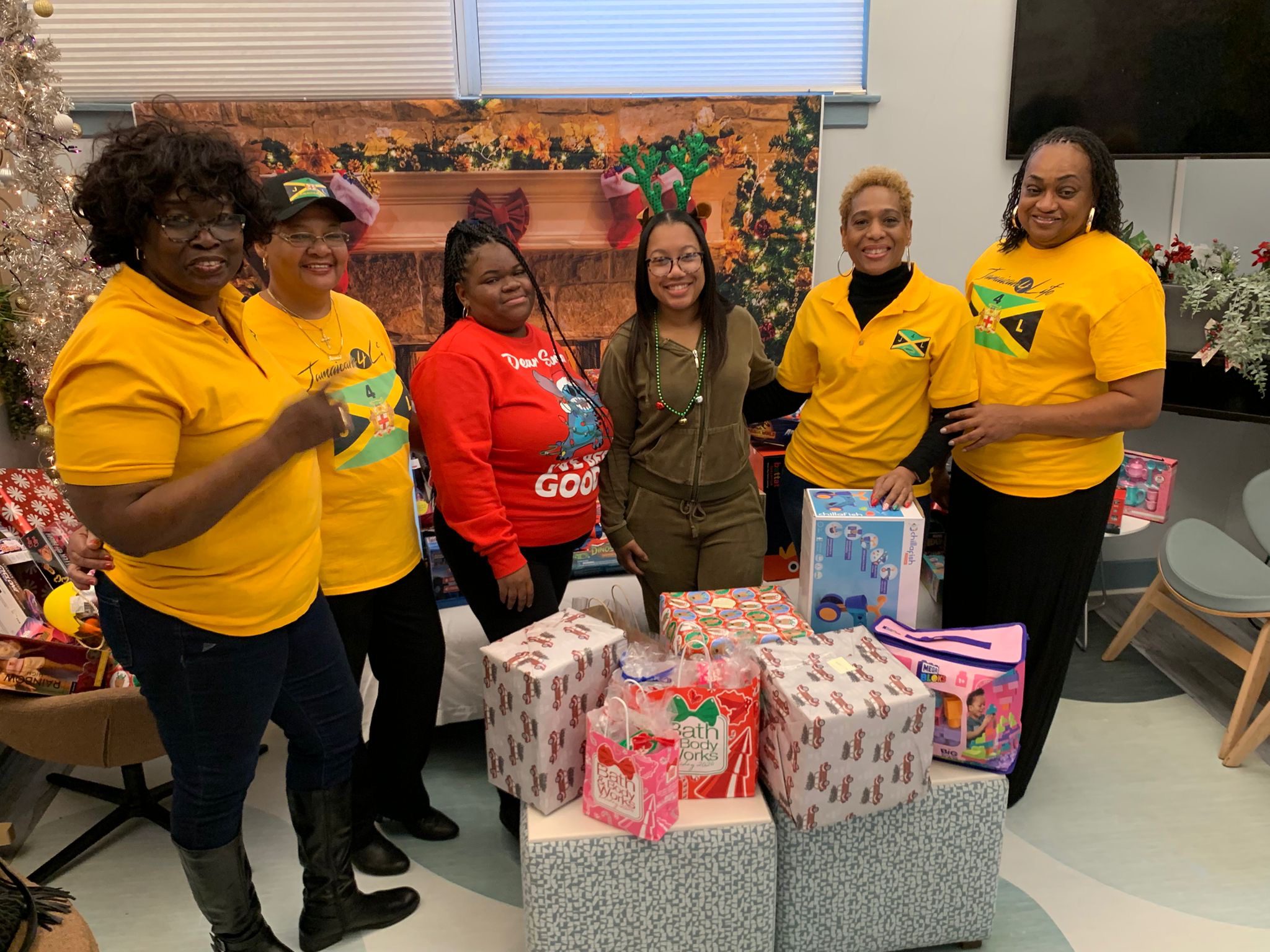 Group celebrating with wrapped Christmas gifts.