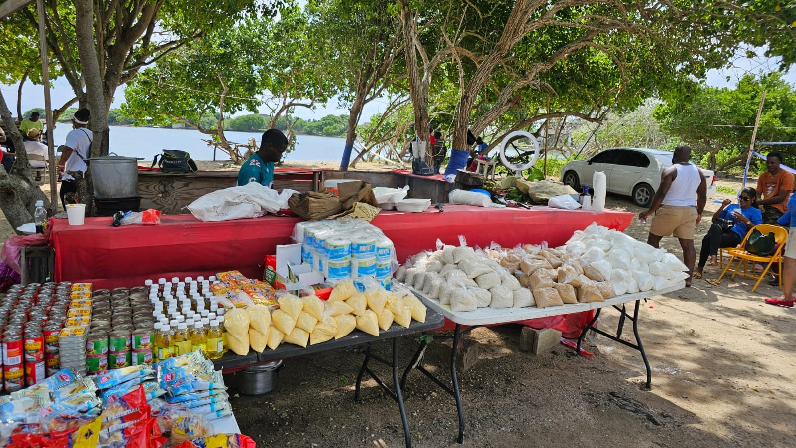 Outdoor market stall with various packaged goods.
