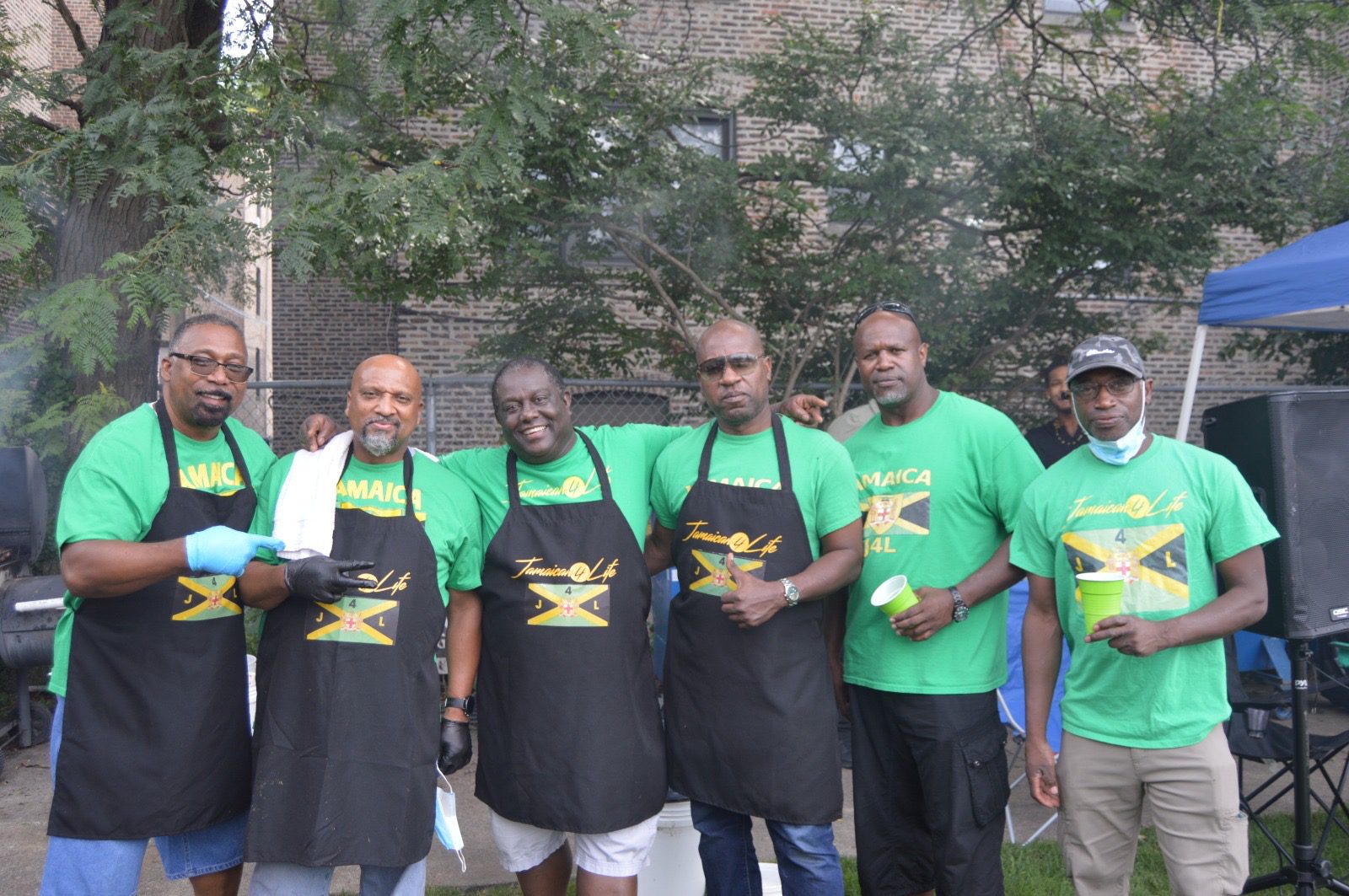 Group of men in matching green shirts.