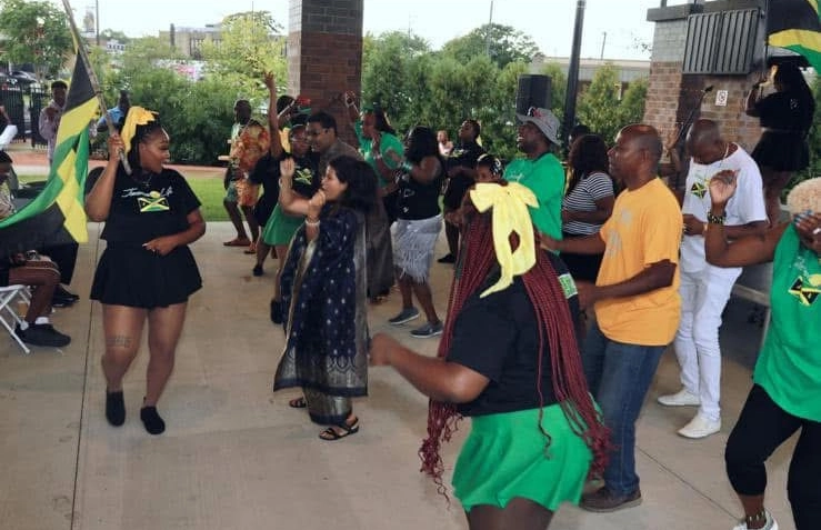 People dancing at a lively outdoor event.