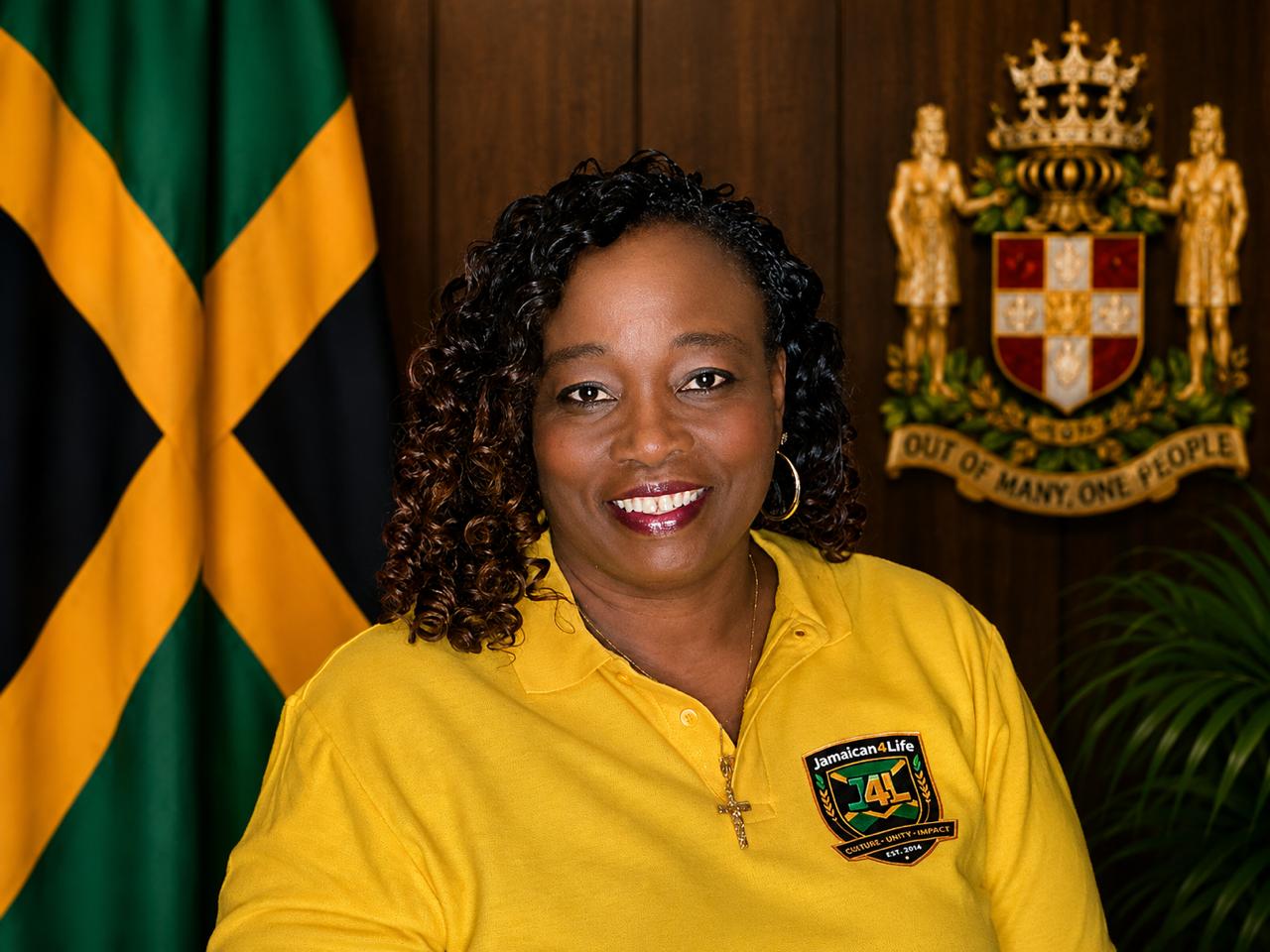 Smiling woman with Jamaican flag background.