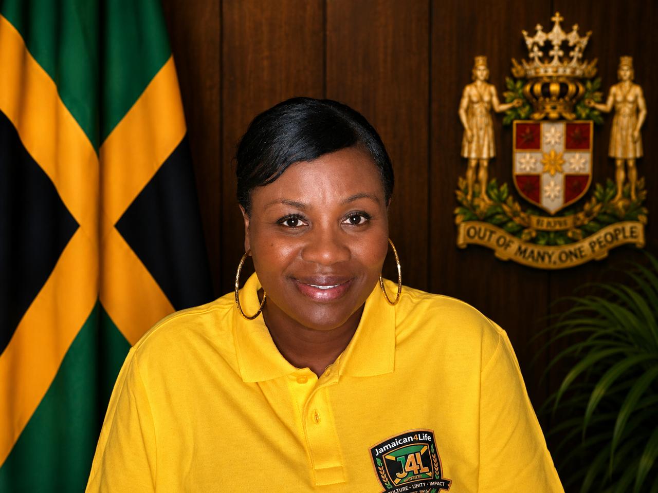 Smiling woman in yellow shirt, Jamaican flag.