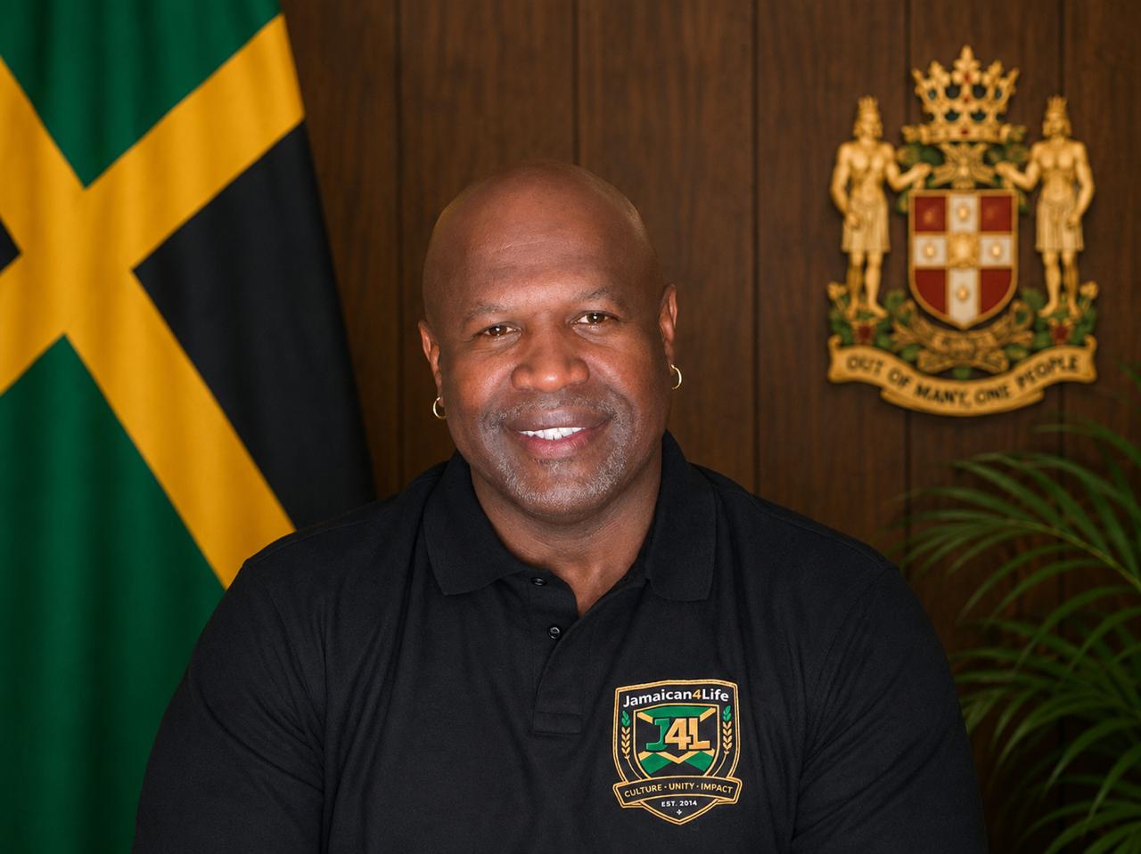 Man smiling with Jamaican flag background.