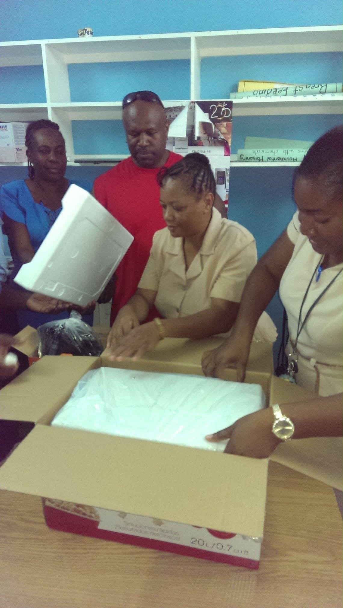 Group unpacking medical supplies from box