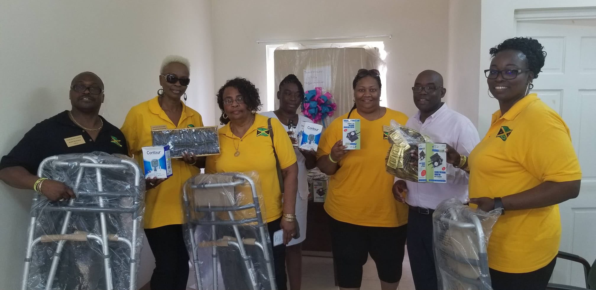 Group holding walkers and medical supplies indoors
